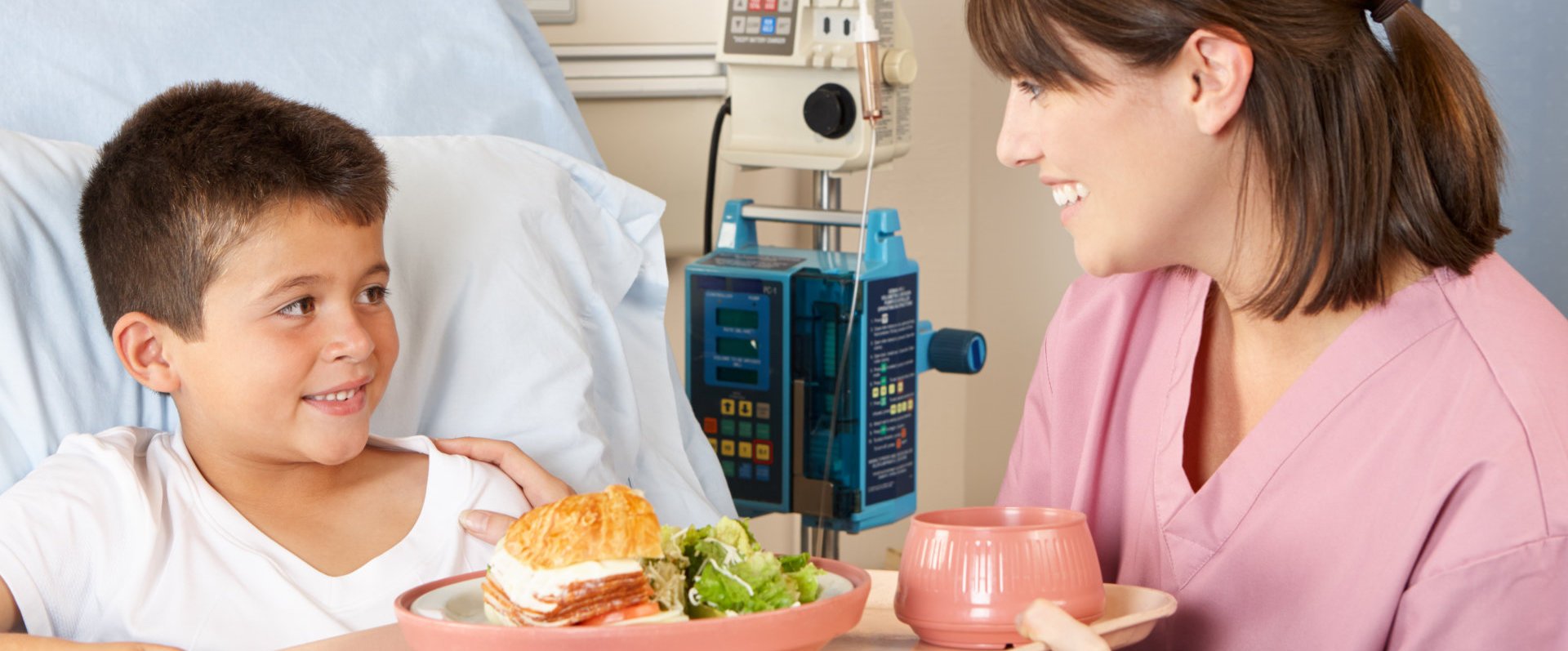 nurse serving food to patient